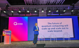 Dr. Stephanie Simmons on stage presenting her keynote at Quantum World Congress. 